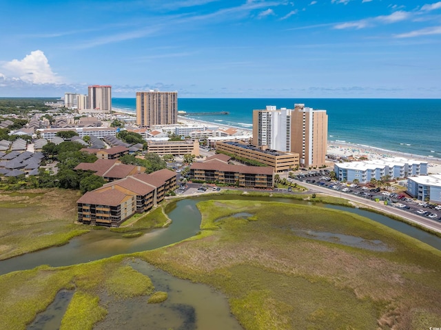 drone / aerial view with a water view and a beach view