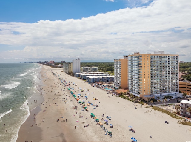 drone / aerial view featuring a water view and a beach view