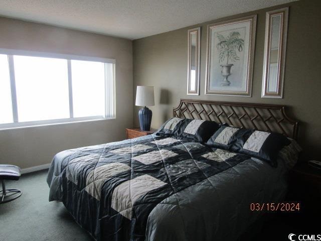 bedroom featuring carpet flooring and a textured ceiling