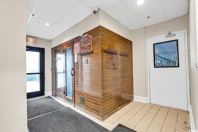 interior space with a paneled ceiling, tile patterned flooring, and recessed lighting