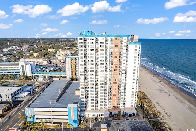 drone / aerial view featuring a water view and a view of the beach