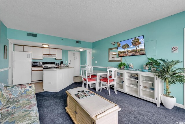 carpeted living room featuring a textured ceiling