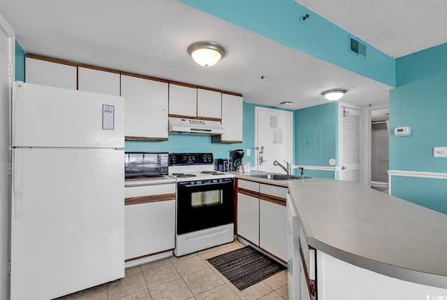 kitchen with white appliances, light tile patterned floors, a textured ceiling, white cabinets, and sink