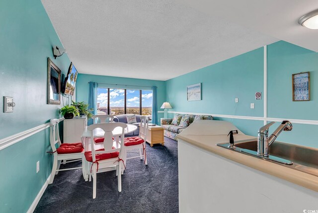 carpeted living room featuring a textured ceiling