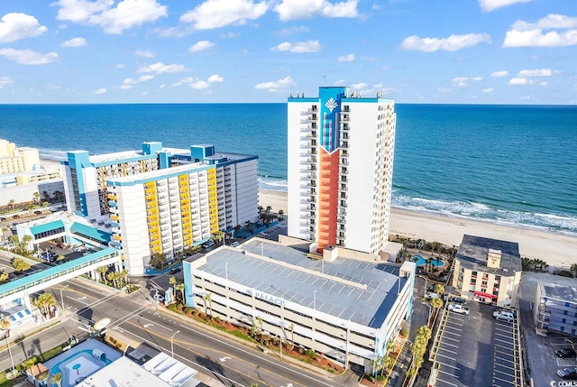 drone / aerial view featuring a water view and a beach view