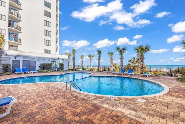 pool featuring fence and a patio