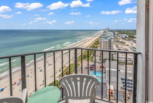 balcony featuring a beach view and a water view