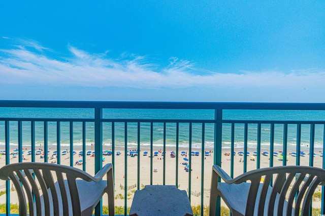 balcony with a water view and a beach view