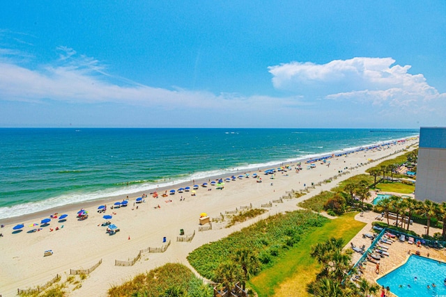 drone / aerial view featuring a water view and a beach view