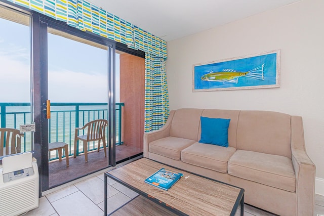 tiled living room featuring a water view