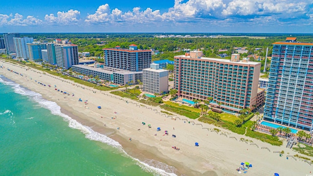 birds eye view of property with a water view and a view of the beach