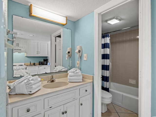 full bathroom featuring shower / bath combo, vanity, tile patterned flooring, toilet, and a textured ceiling