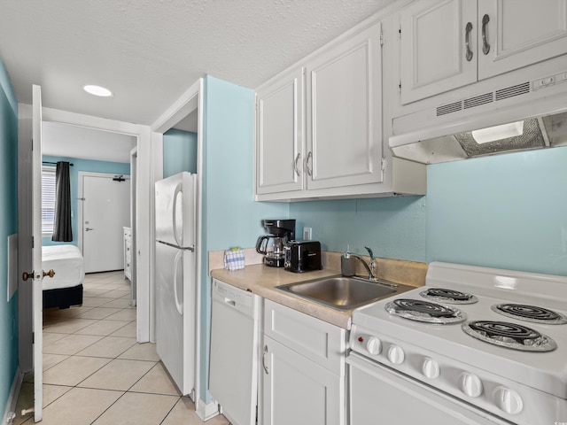 kitchen featuring white cabinets, white appliances, sink, and light tile patterned floors