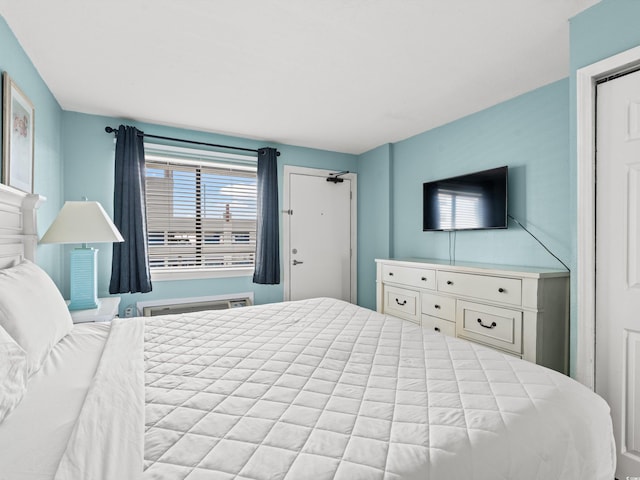 bedroom featuring a wall unit AC