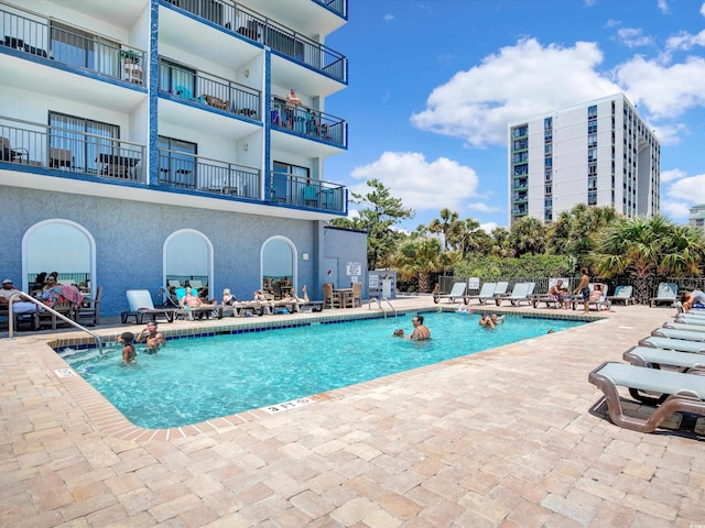 view of swimming pool with a patio