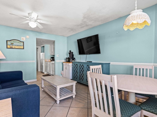 living room featuring ceiling fan and light tile patterned flooring