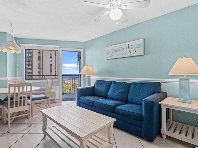 tiled living room featuring ceiling fan