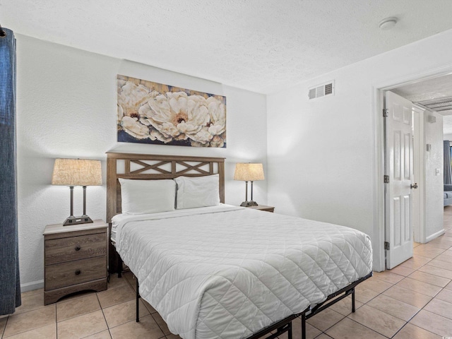 tiled bedroom featuring a textured ceiling