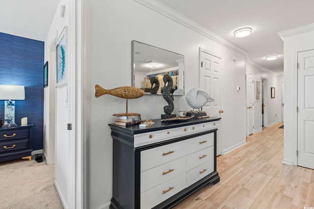 kitchen featuring pendant lighting, light wood-type flooring, appliances with stainless steel finishes, and crown molding