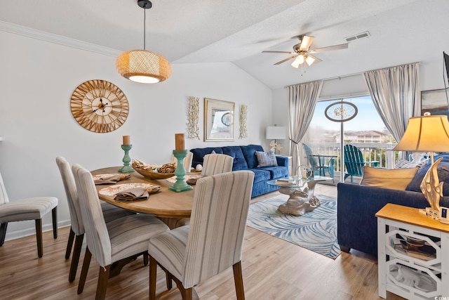 dining area featuring lofted ceiling, hardwood / wood-style floors, and ceiling fan
