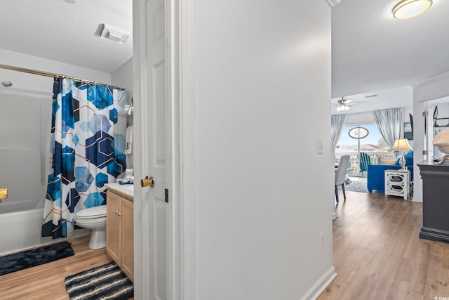 full bathroom featuring shower / tub combo, ceiling fan, toilet, wood-type flooring, and vanity
