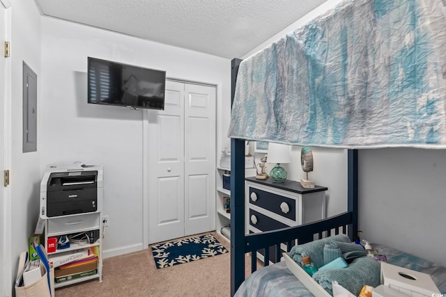 bedroom featuring electric panel, carpet floors, a closet, and a textured ceiling