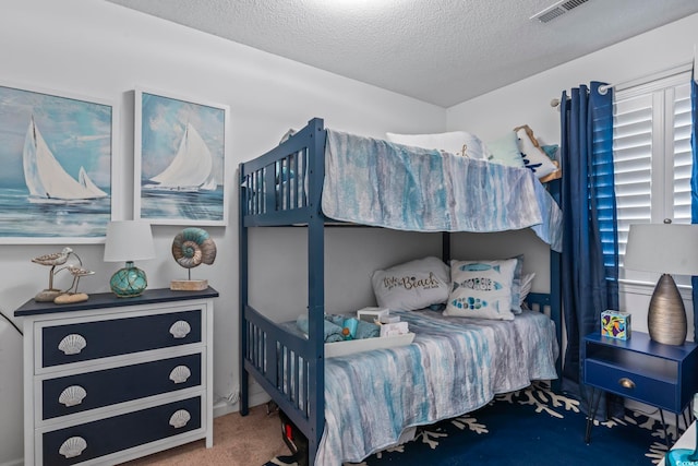 carpeted bedroom with a textured ceiling