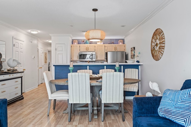 dining space with ornamental molding and light wood-type flooring