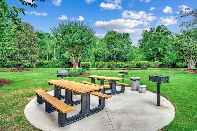 view of community featuring a yard and a patio