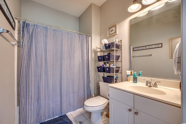 bathroom with vanity, walk in shower, tile patterned floors, and toilet