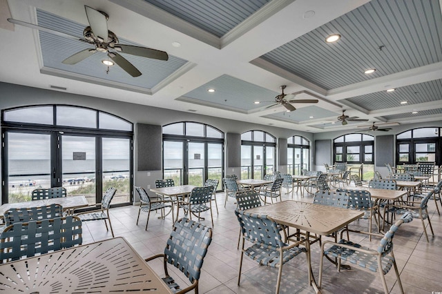 dining area featuring beamed ceiling, ornamental molding, a water view, and coffered ceiling