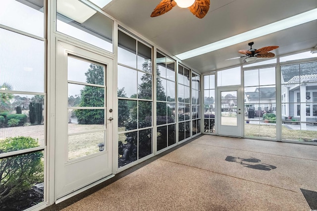 unfurnished sunroom featuring ceiling fan