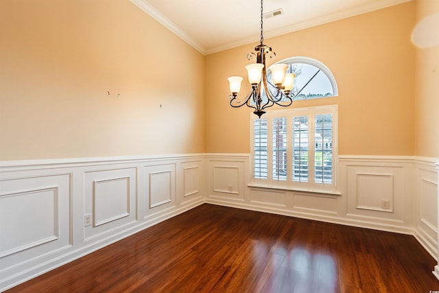 unfurnished dining area featuring a notable chandelier, ornamental molding, and dark wood-type flooring