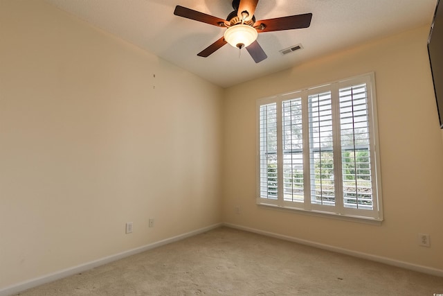 carpeted empty room with ceiling fan and a healthy amount of sunlight