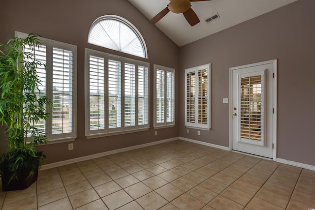 tiled empty room with ceiling fan and lofted ceiling