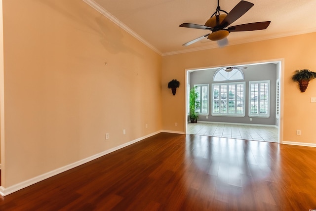 spare room with hardwood / wood-style floors, ceiling fan, and ornamental molding