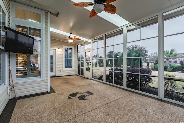 unfurnished sunroom featuring ceiling fan