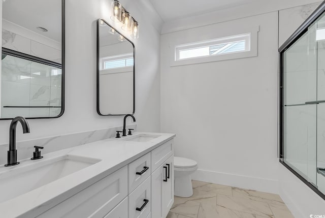 bathroom featuring marble look tiles, an enclosed shower, toilet, double vanity, and baseboards