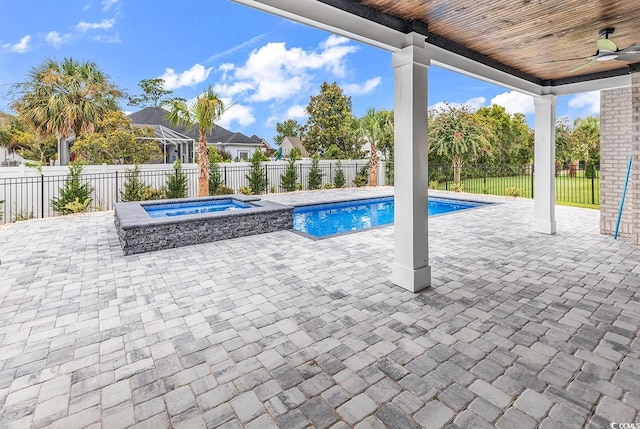 view of pool with a ceiling fan, an in-ground hot tub, a fenced backyard, and a patio