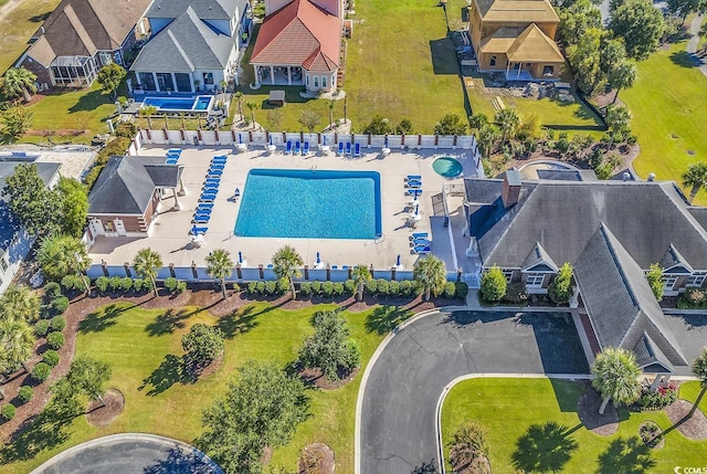 aerial perspective of suburban area featuring a pool