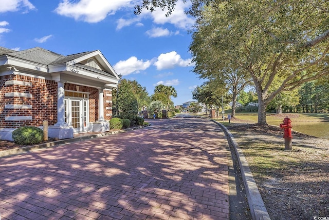 view of home's exterior with brick siding and french doors