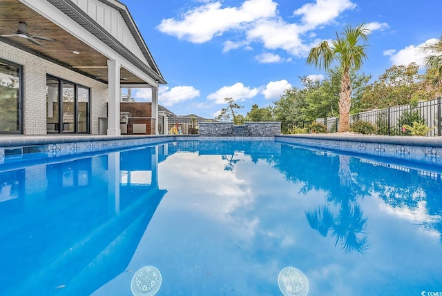 view of pool with fence and ceiling fan