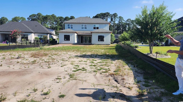 rear view of house with a lawn