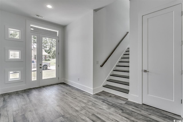 foyer entrance with light hardwood / wood-style floors