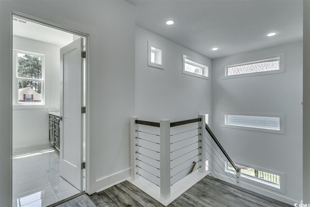 stairs with hardwood / wood-style flooring