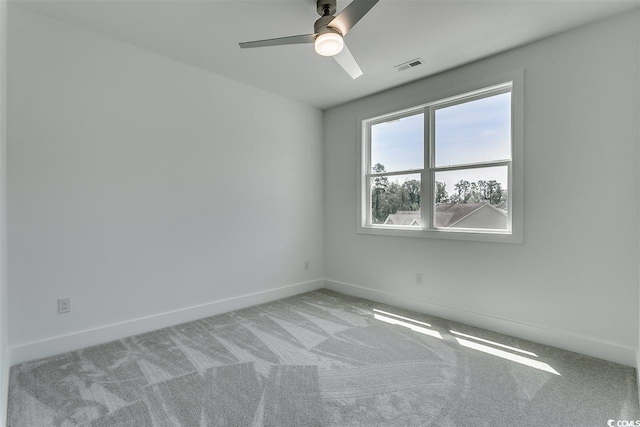 empty room featuring light carpet and ceiling fan