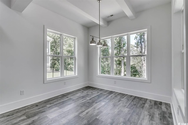 unfurnished dining area with dark hardwood / wood-style floors and beam ceiling