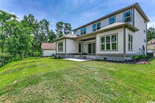 rear view of house featuring a yard and a patio area