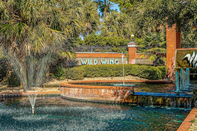 community / neighborhood sign with a water view