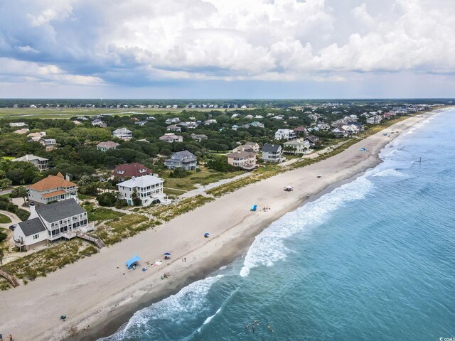 birds eye view of property featuring a water view and a view of the beach